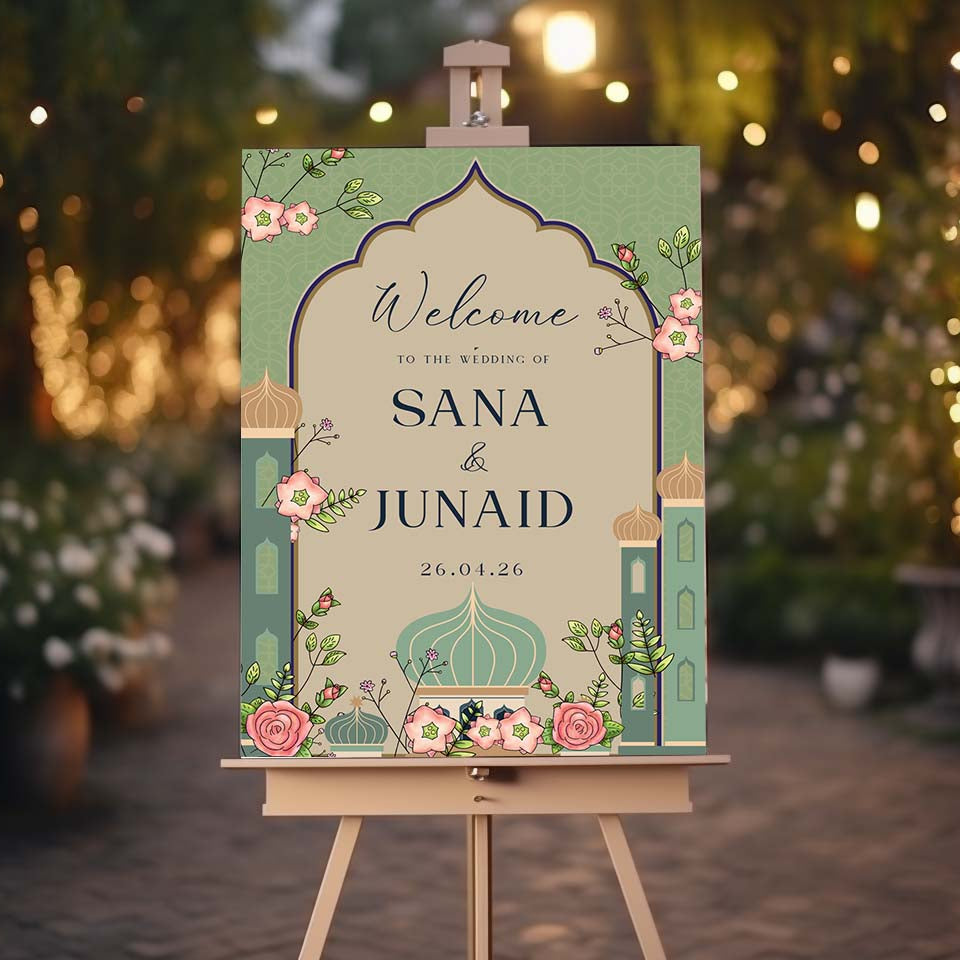 Wedding welcome sign on an easel with decorative elements against a blurred outdoor background.