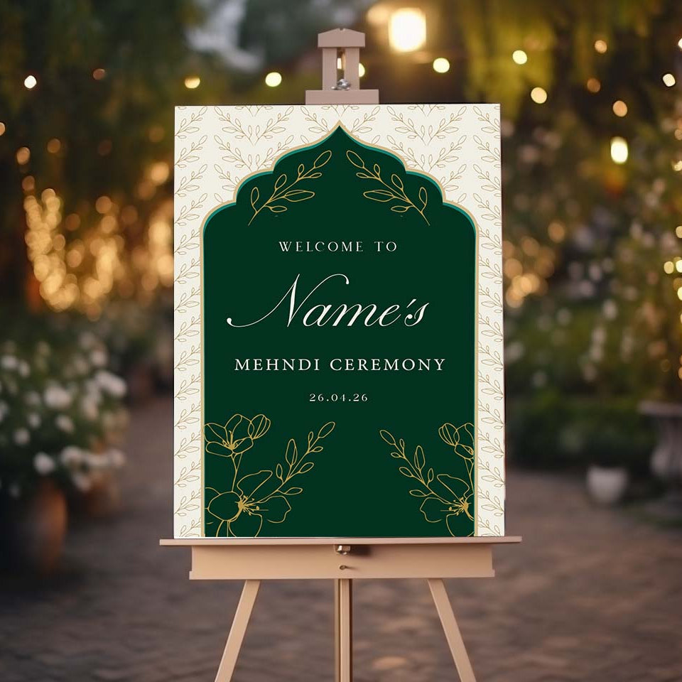 Decorative sign for a Mehndi ceremony on an easel with a blurred festive background.